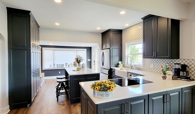 kitchen remodel with dark cabinetry and white granite countertops