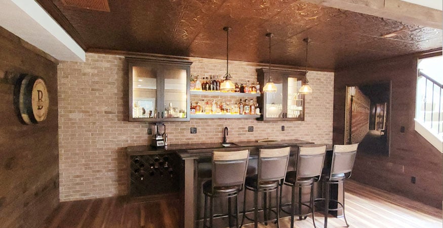 basement remodel bernhardt featuring brick access wall for speakeasy style basement bar
