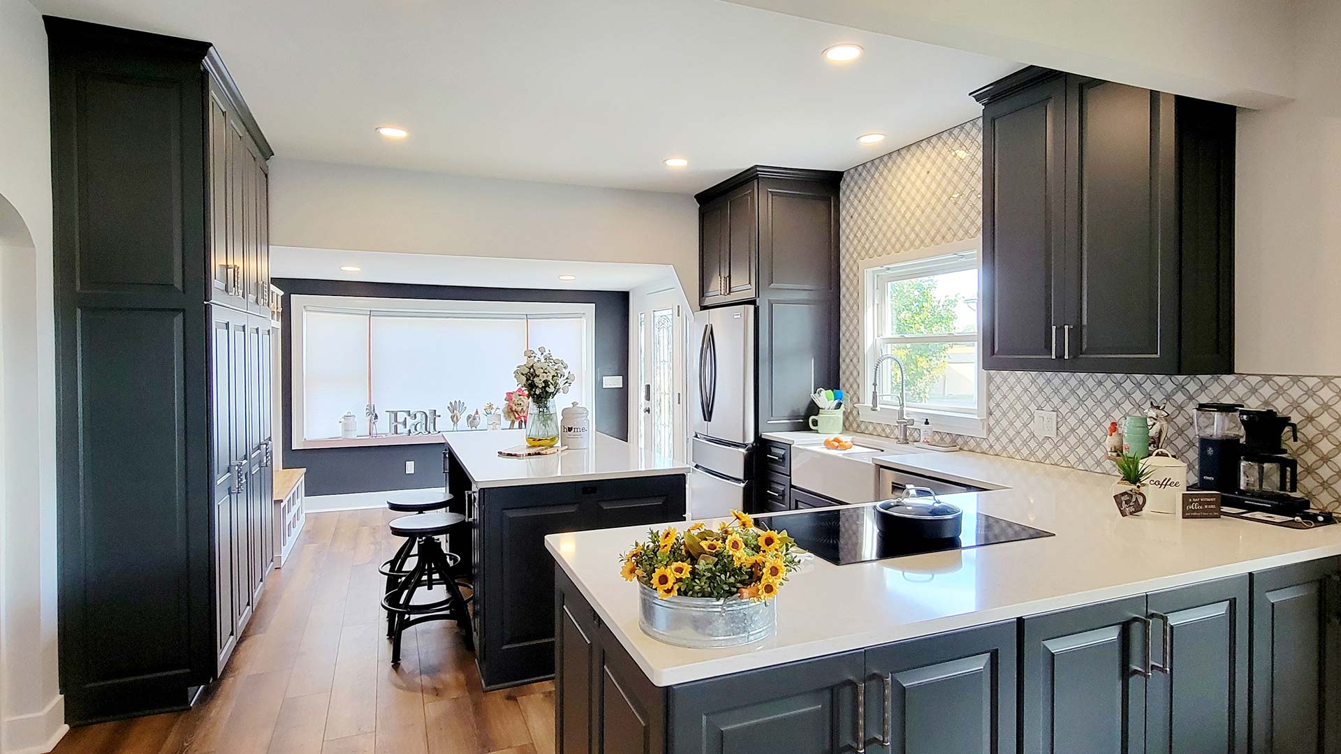 kitchen remodel with dark cabinetry and white granite countertops