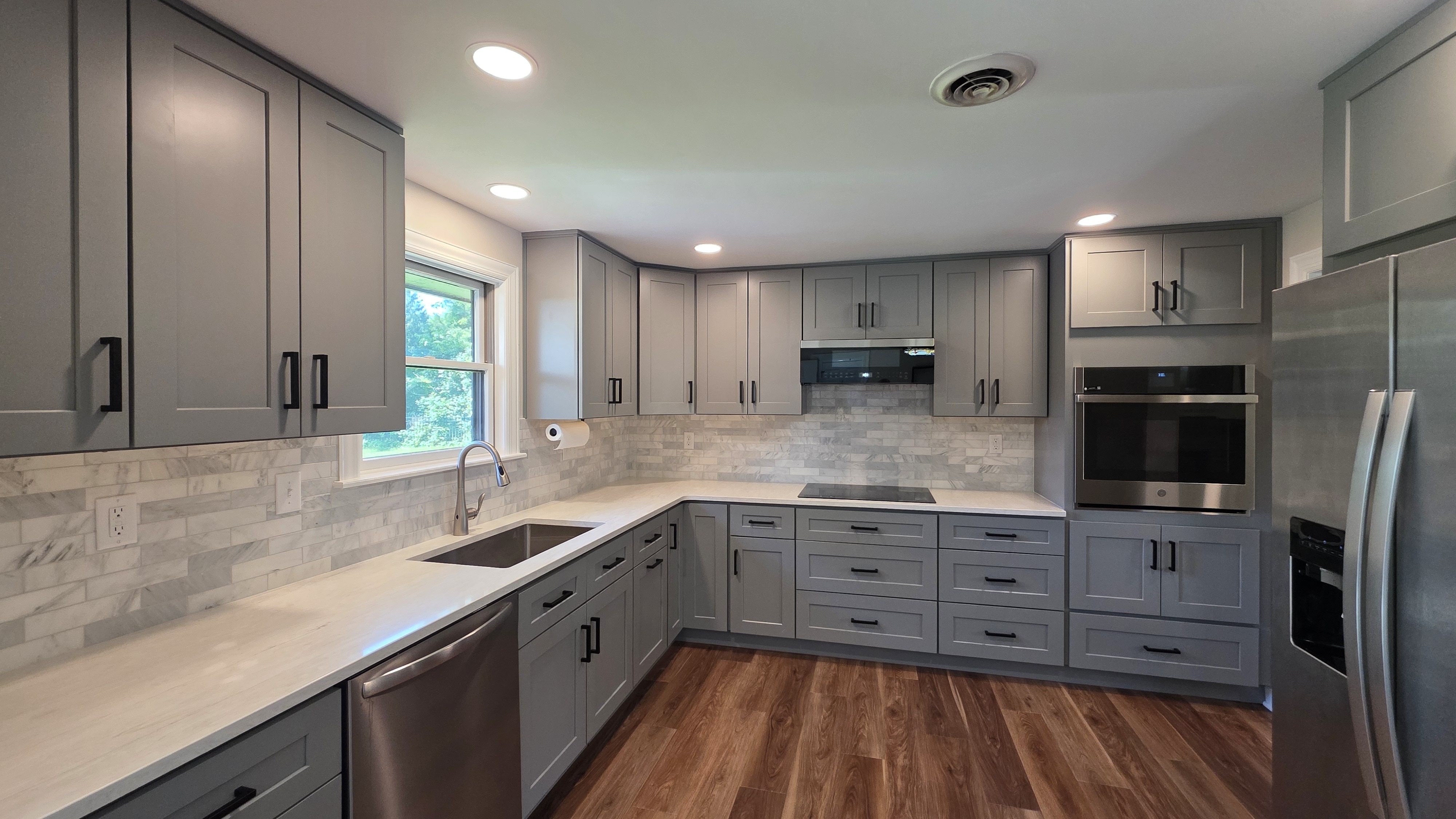 kitchen remodel with white countertops and grey cabinets