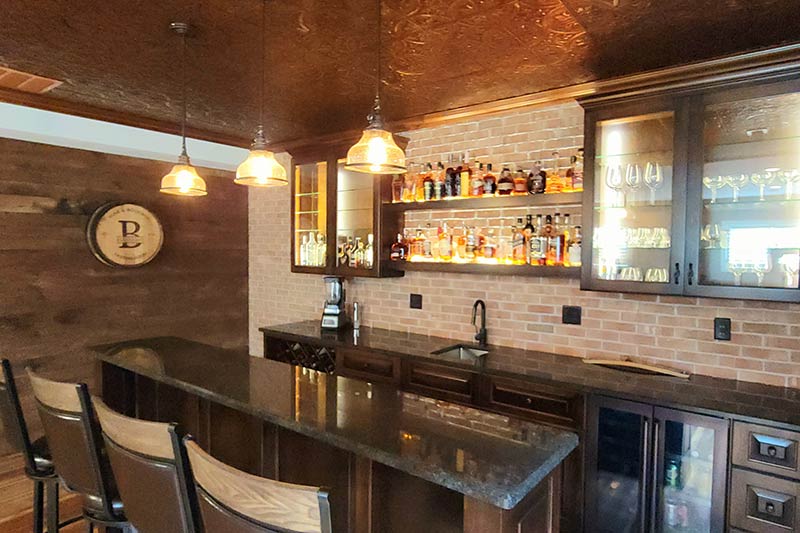 Custom Remodeling featuring basement bar remodel with granite countertops and tin ceiling